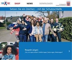 Startseite der Schutzschleife-Kampagne mit lächelnden Menschen und Feuerwehrleuten, die für Respekt und Schutzschleife werben.